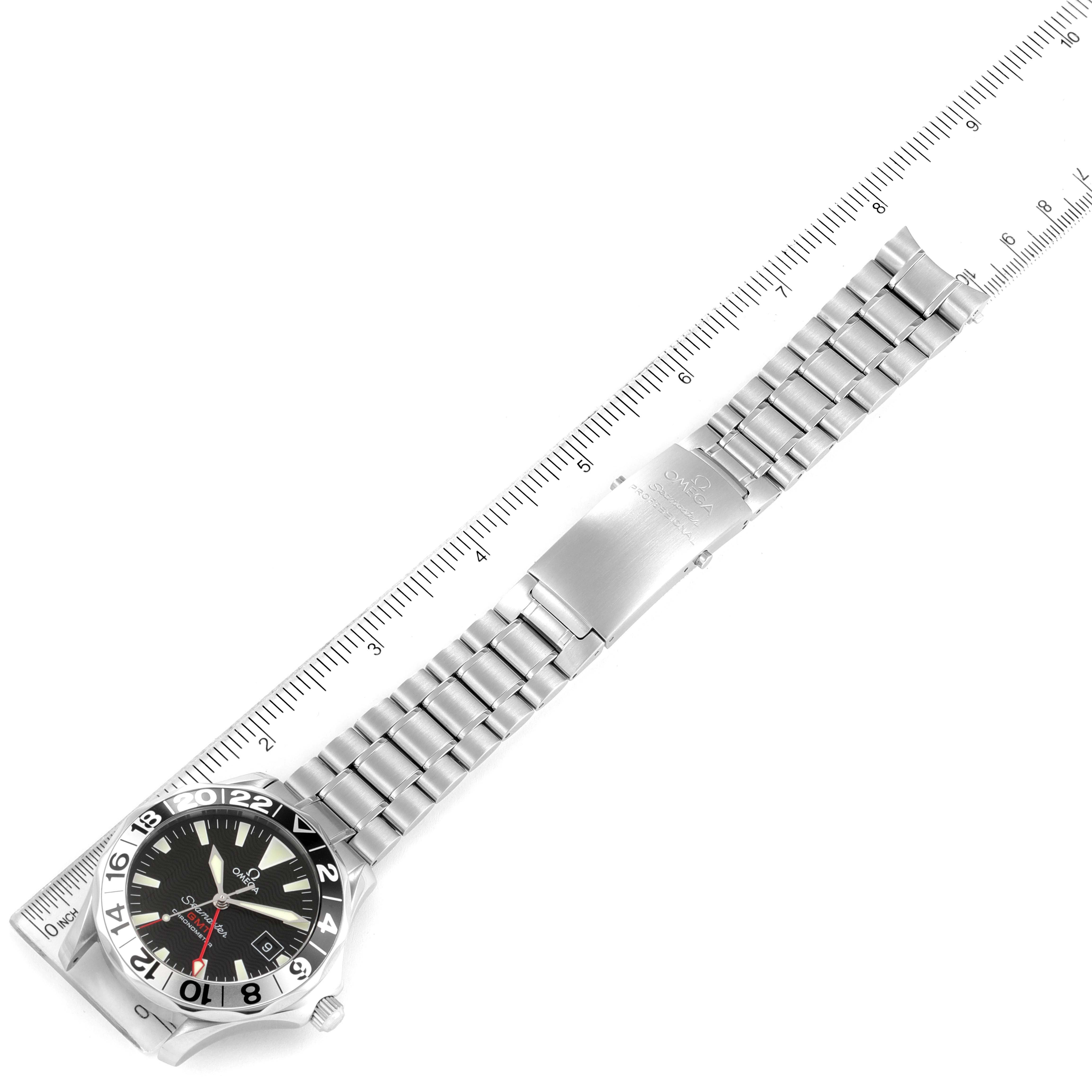The Omega Seamaster 2234.50.00 Men's Stainless Steel Black Dial 2234.50.00 Men's Stainless Steel Black Dial watch is displayed flat, showing the dial, bezel, and metal bracelet with a ruler alongside it.