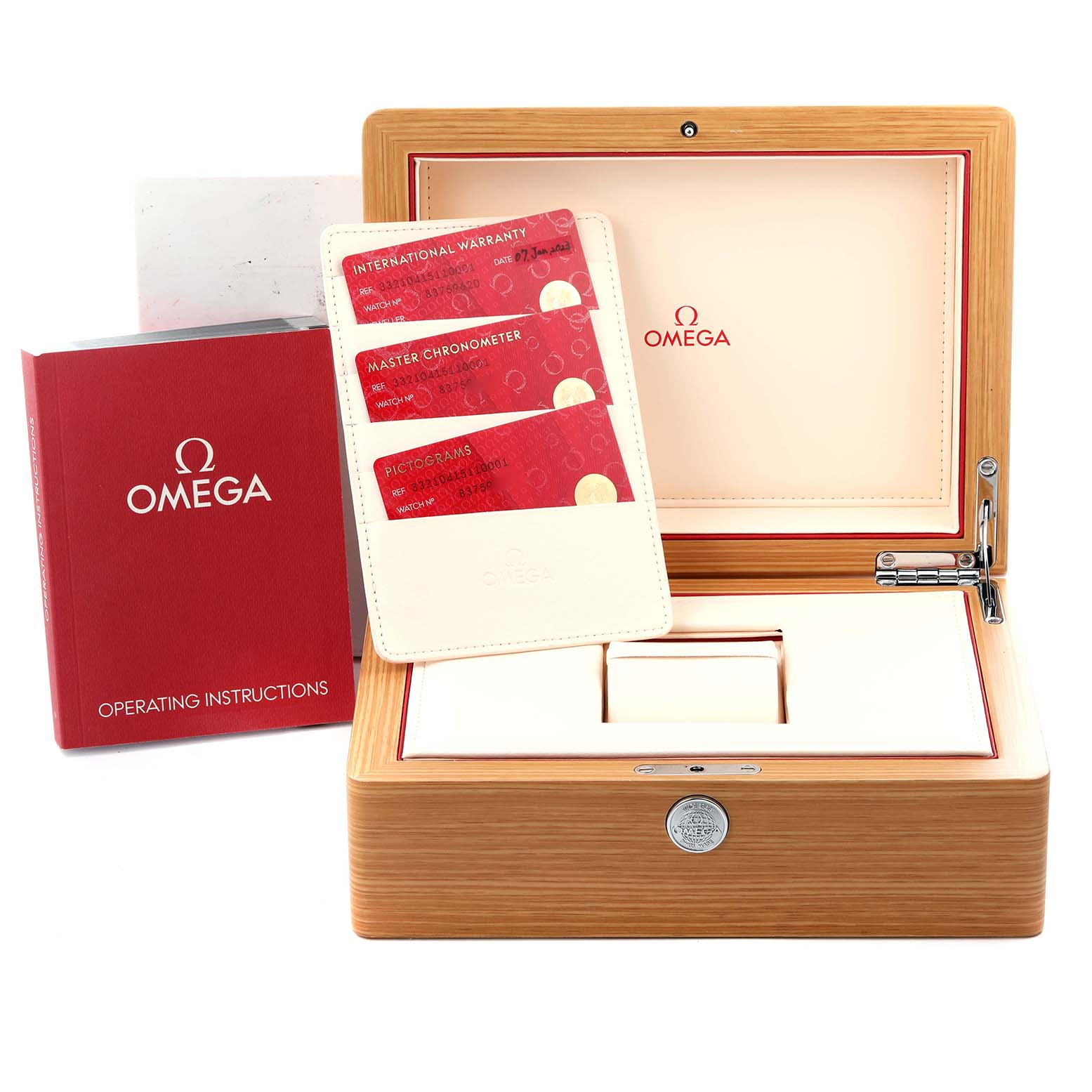 The image shows the Omega Speedmaster 332.10.41.51.10.001 Men's Stainless Steel Green Dial 332.10.41.51.10.001 Men's Stainless Steel Green Dial watch's box, warranty cards, and operating instructions from a front angle.