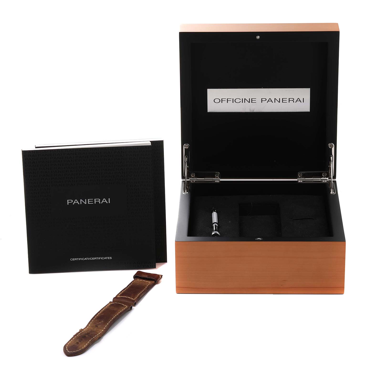 This close-up image shows a Panerai Luminor PAM00441 Men's Ceramic Black Dial PAM00441 Men's Ceramic Black Dial watch box with an extra strap and a booklet.