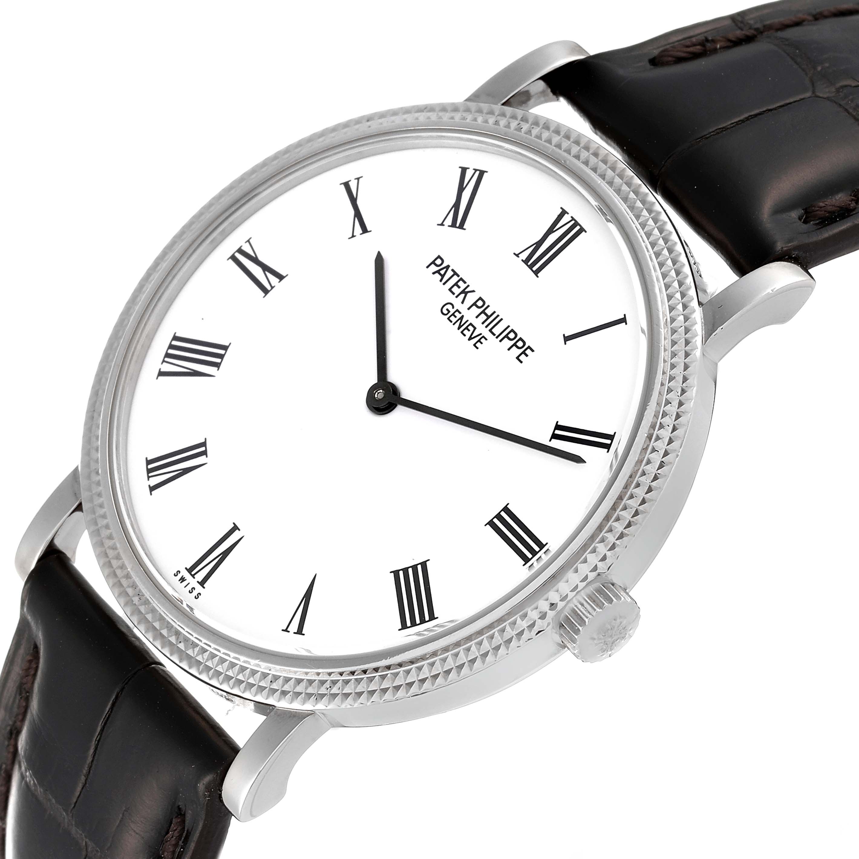 The image shows a Calatrava model watch by Patek Philippe at a tilted angle, highlighting the dial, bezel, and leather strap.