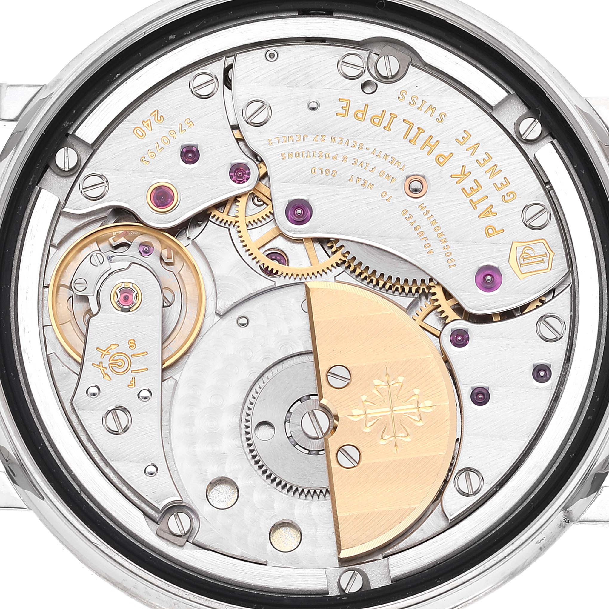 The image shows a close-up view of the movement of a Patek Philippe Calatrava 5120G Men's White Gold White Dial 5120G Men's White Gold White Dial watch, highlighting gears and components.