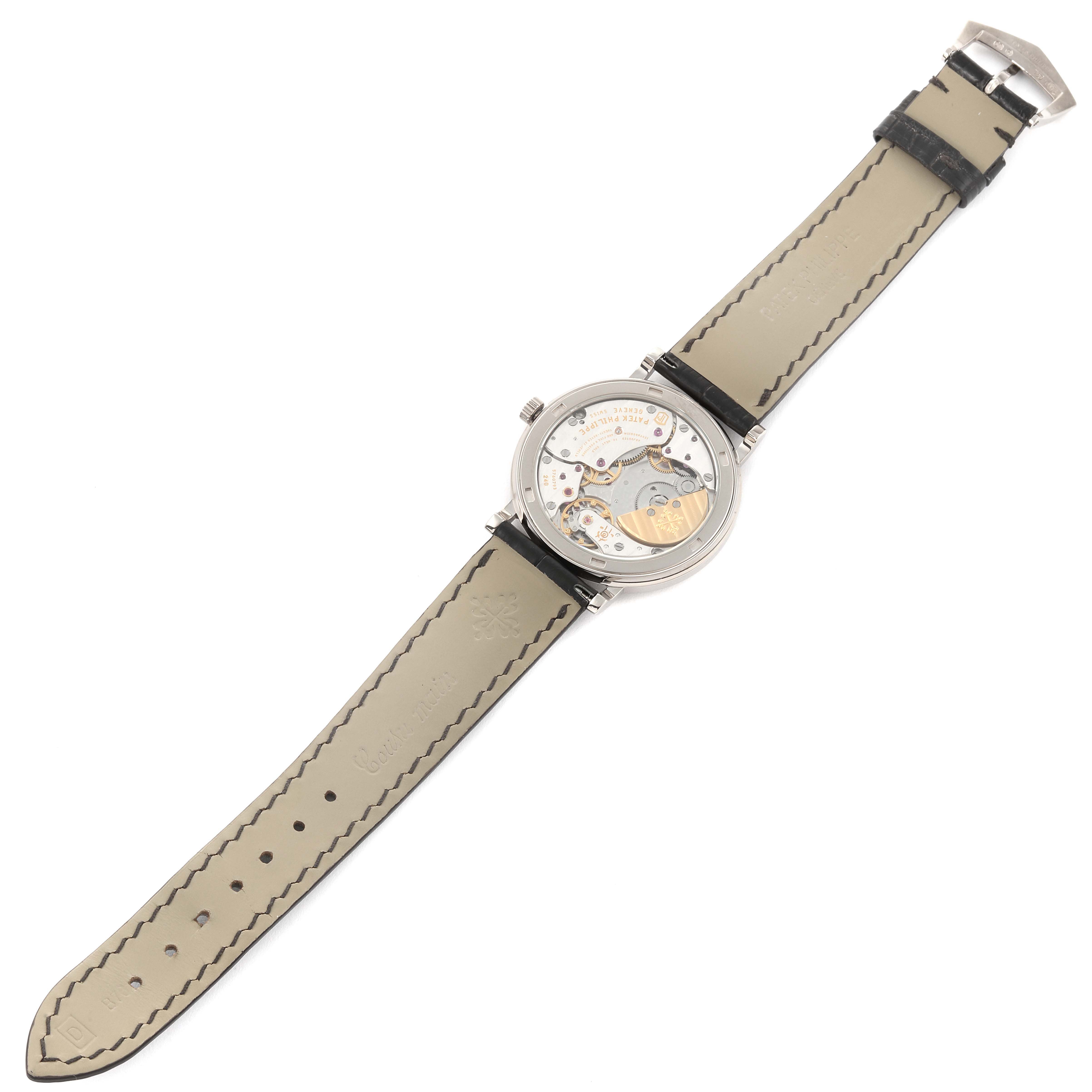 The image shows the back view of a Patek Philippe Calatrava 5120G Men's White Gold White Dial 5120G Men's White Gold White Dial watch, revealing the inner mechanisms and leather strap.