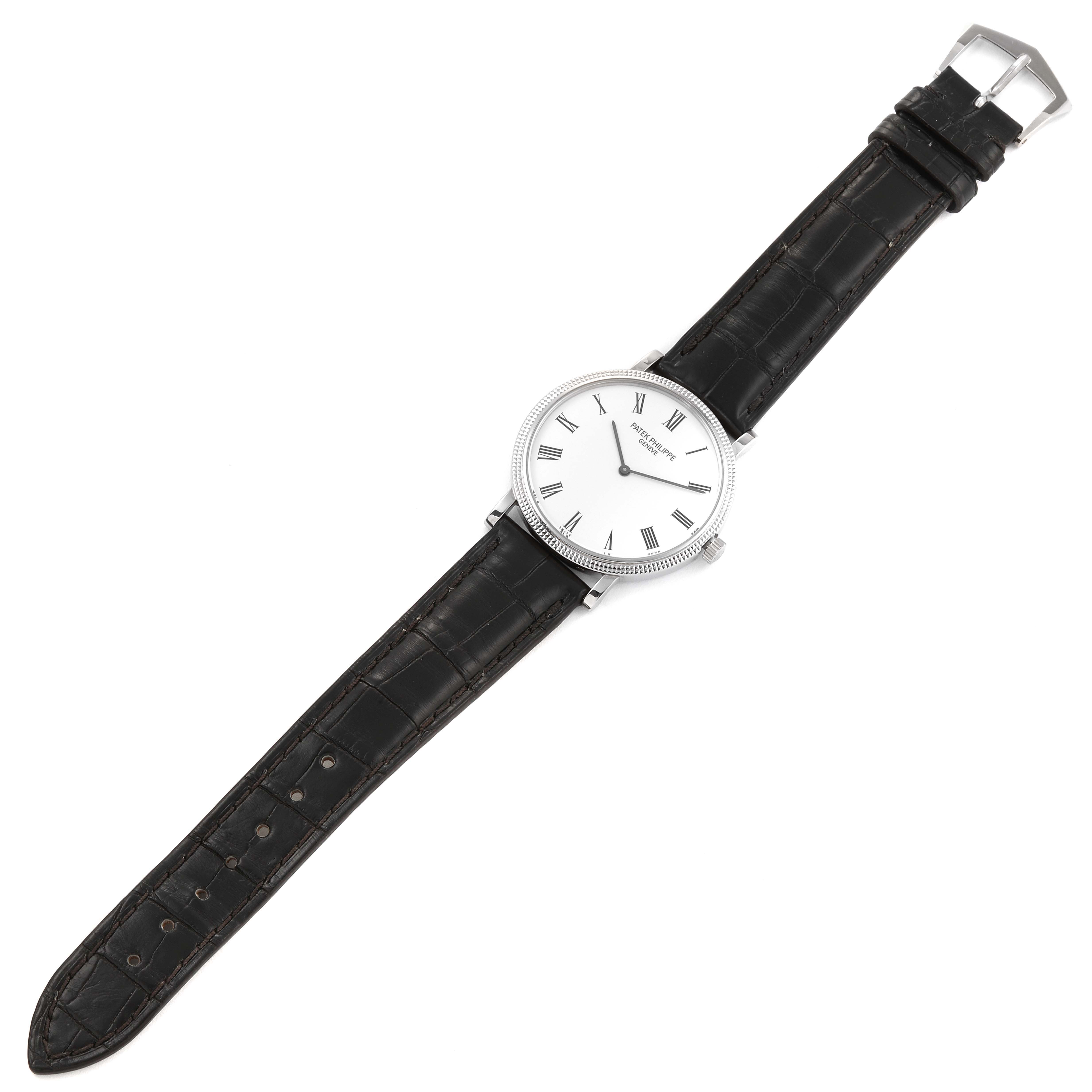 The image shows a top-down view of a Patek Philippe Calatrava 5120G Men's White Gold White Dial 5120G Men's White Gold White Dial watch with a white dial and black leather strap.