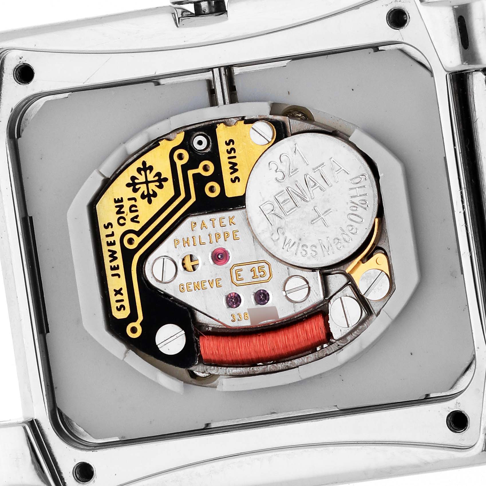 The image shows the back view of a Patek Philippe Twenty-4 4910/10A-011 Women's Stainless Steel Silver Dial 4910/10A-011 Women's Stainless Steel Silver Dial watch, highlighting its movement and battery compartment.