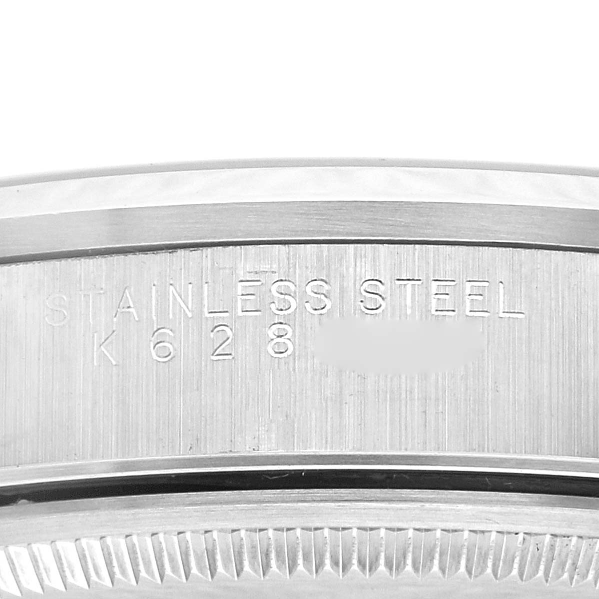 The image displays the side edge of a stainless steel Rolex Air-King 14000 Men's Stainless Steel Blue Dial 14000 Men's Stainless Steel Blue Dial watch case, showing engraved text.