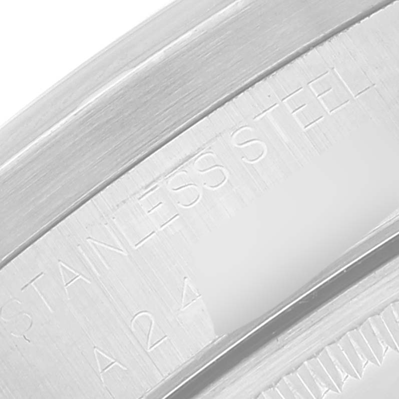 This close-up image shows the stainless steel case edge and part of the engraved serial number of the Rolex Air-King 14010 Men's Stainless Steel Black Dial 14010 Men's Stainless Steel Black Dial watch.