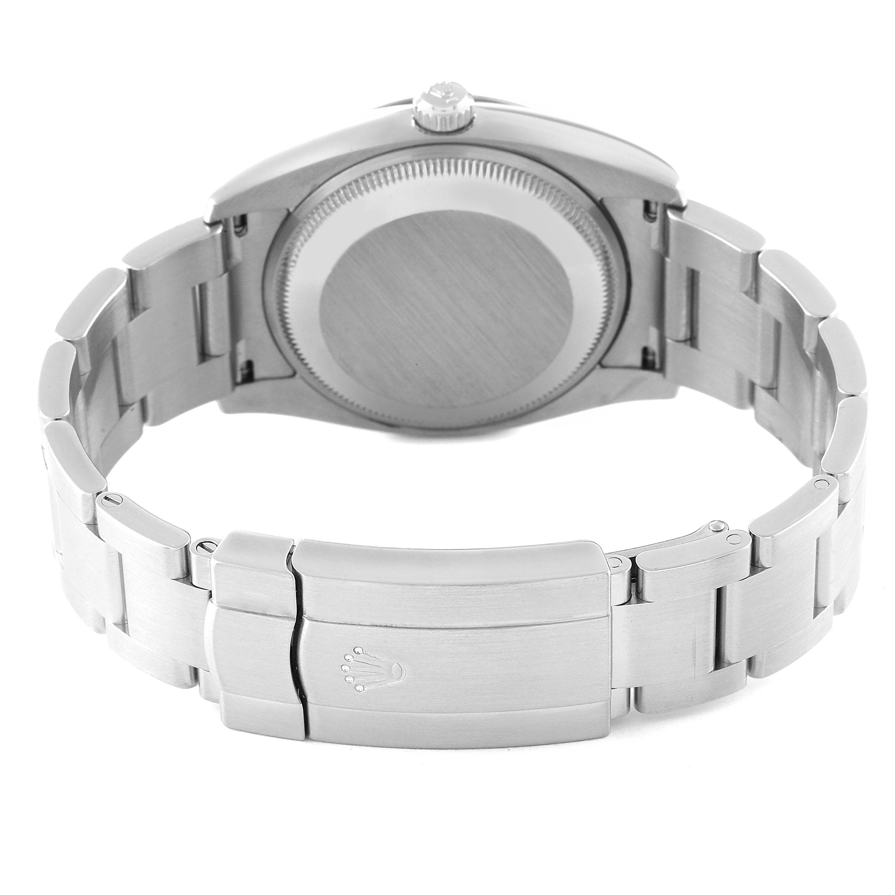 The Rolex Air-King 114234 Men's Stainless Steel Blue Dial 114234 Men's Stainless Steel Blue Dial watch is shown from the back, displaying the case, case back, crown, and bracelet with the clasp.