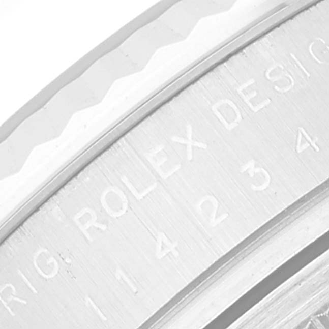 The image shows a close-up angle of the engraved bezel of an Air-King model Rolex watch.