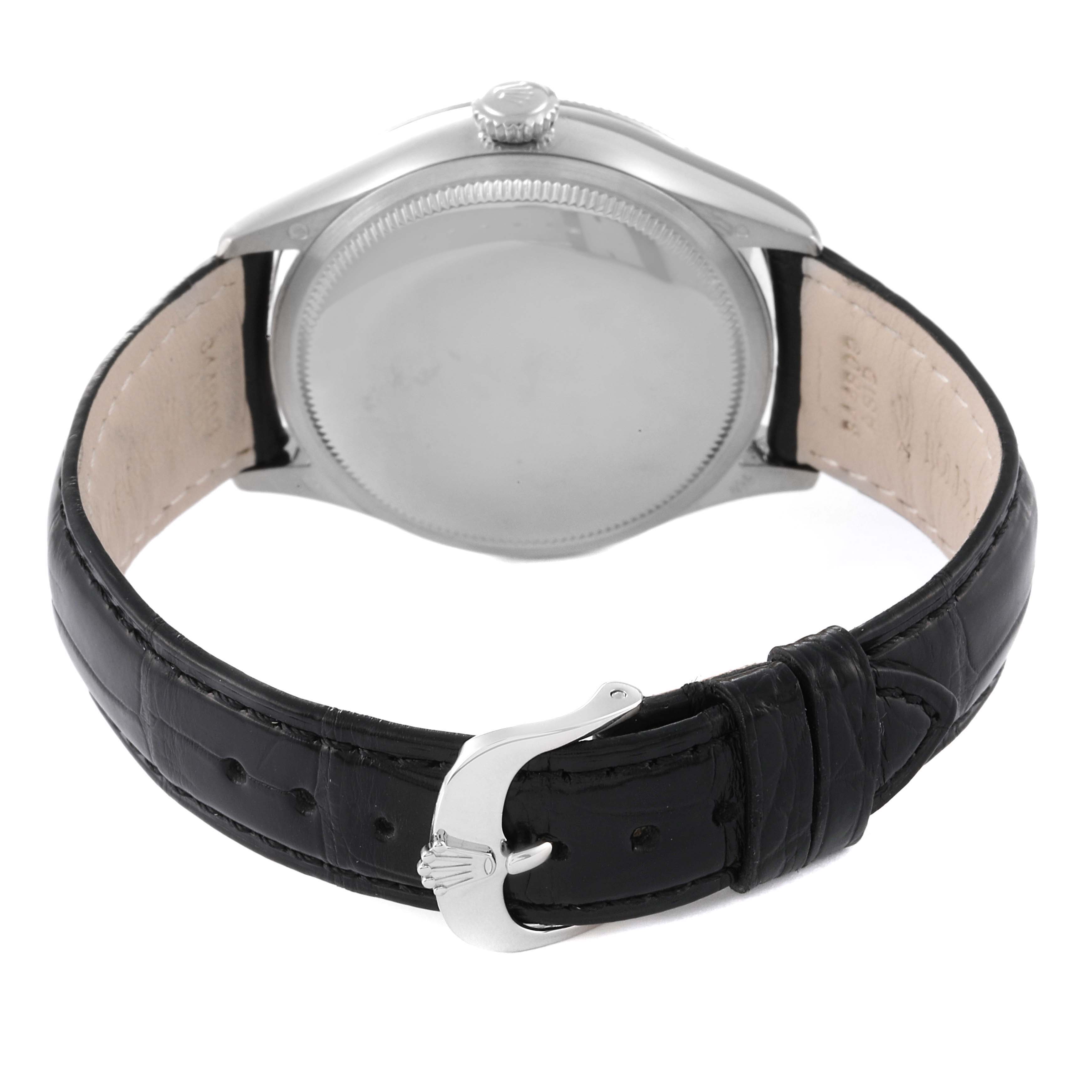 The image shows the back view of a Rolex Cellini 50519 Men
s Stainless Steel Silver Dial 50519 Men
s Stainless Steel Silver Dial watch, including the case, crown, and black leather strap with a clasp.