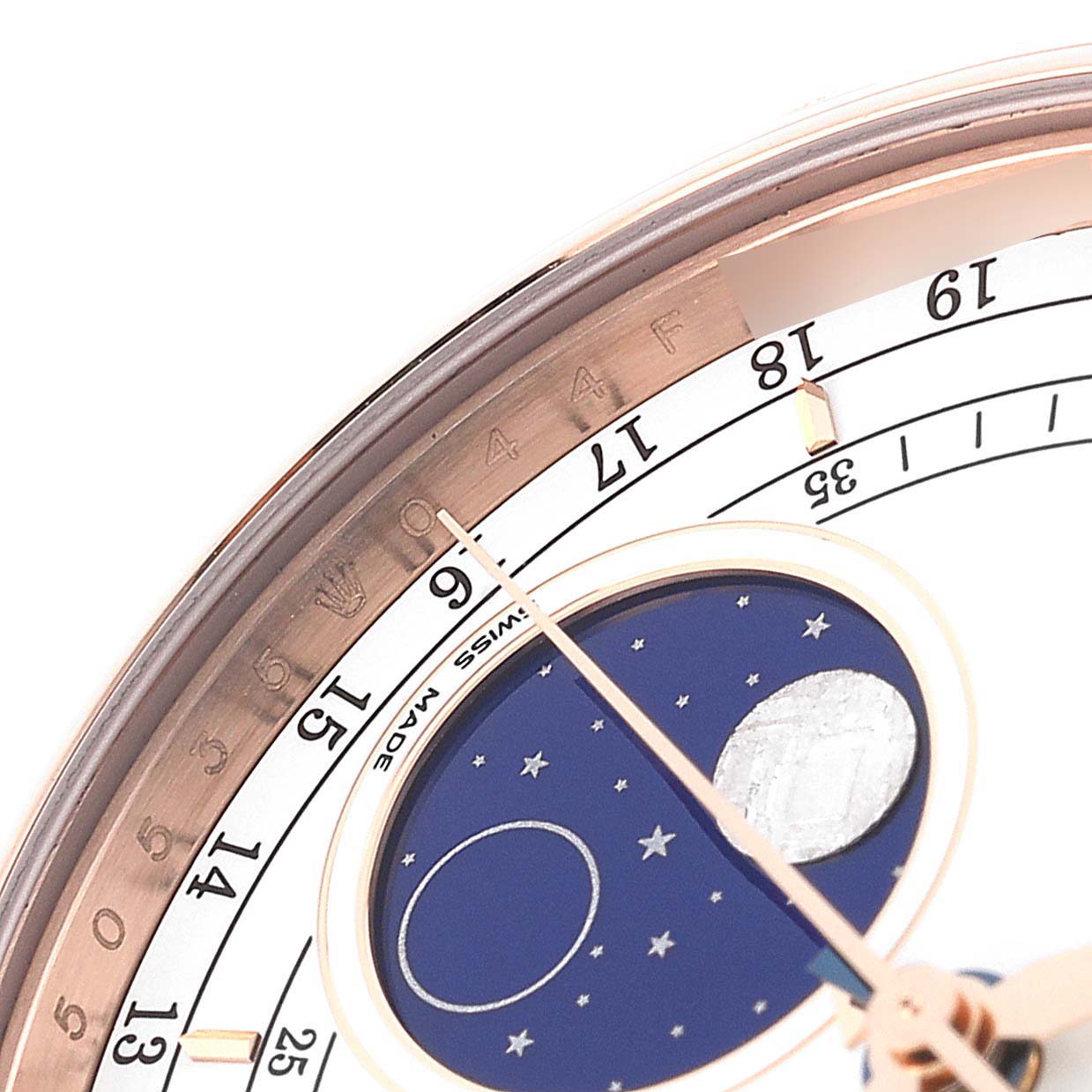 The image shows a close-up of the Rolex Cellini 50535 Men
s Rose Gold White Dial 50535 Men
s Rose Gold White Dial watch, focusing on its moonphase dial and an engraved bezel.