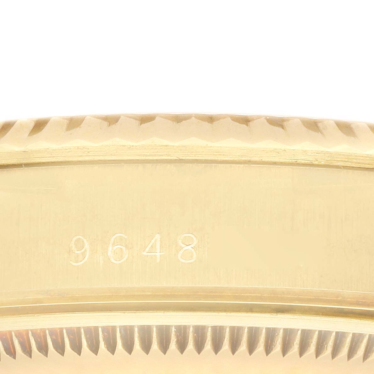 The image shows a close-up side view of the Rolex Date watch bezel with engraved numbers.