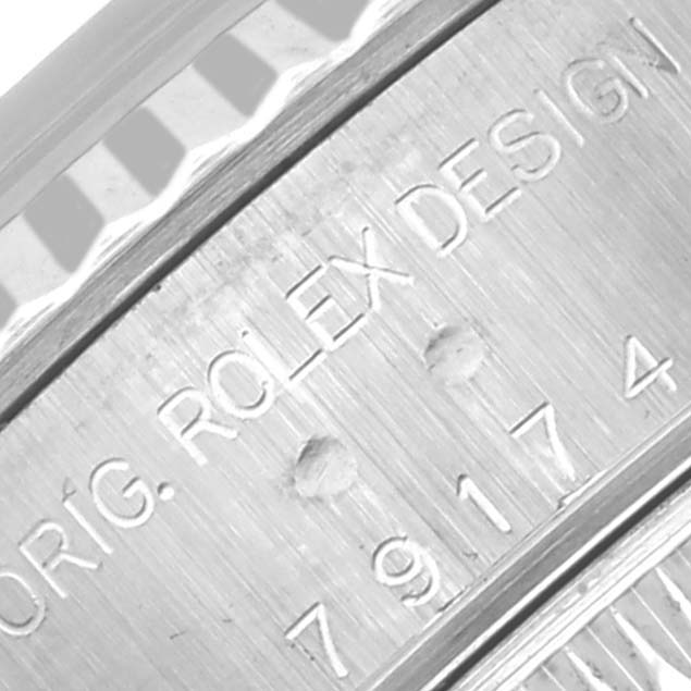 The image shows a close-up of the side engraving on the bezel of a Rolex Datejust 79174 Women's Stainless Steel Silver Dial 79174 Women's Stainless Steel Silver Dial watch.