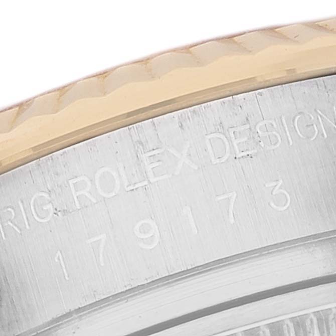 This image shows a close-up of the bezel and serrated edge of the case back of a Rolex Datejust 179173 Women's Steel and Gold (two tone) Champagne Dial 179173 Women's Steel and Gold (two tone) Champagne Dial watch.