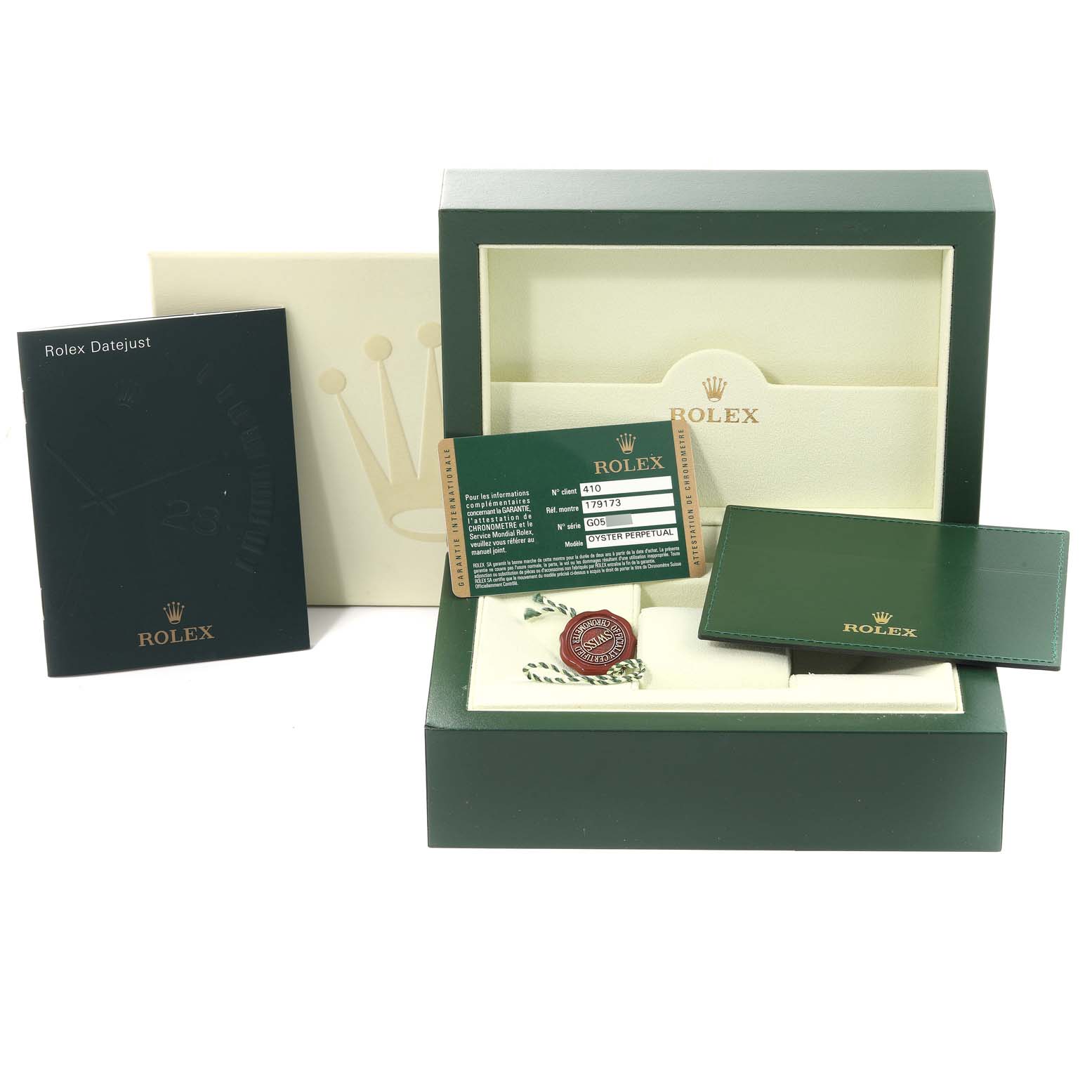 The image shows accessories for a Rolex Datejust 179173 Women's Steel and Gold (two tone) Champagne Dial 179173 Women's Steel and Gold (two tone) Champagne Dial, including the box, warranty cards, booklet, and tags.