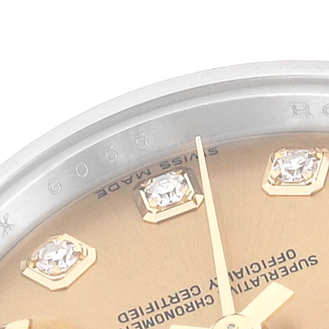 This close-up image of a Rolex Datejust 179173 Women's Steel and Gold (two tone) Champagne Dial 179173 Women's Steel and Gold (two tone) Champagne Dial watch shows part of the bezel, dial, diamonds, and hour markers.