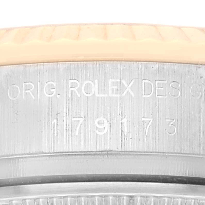 This image shows a close-up of the case side of the Rolex Datejust 179173 Women's Steel and Gold (two tone) Champagne Dial 179173 Women's Steel and Gold (two tone) Champagne Dial watch, highlighting the engraved model number 179173.