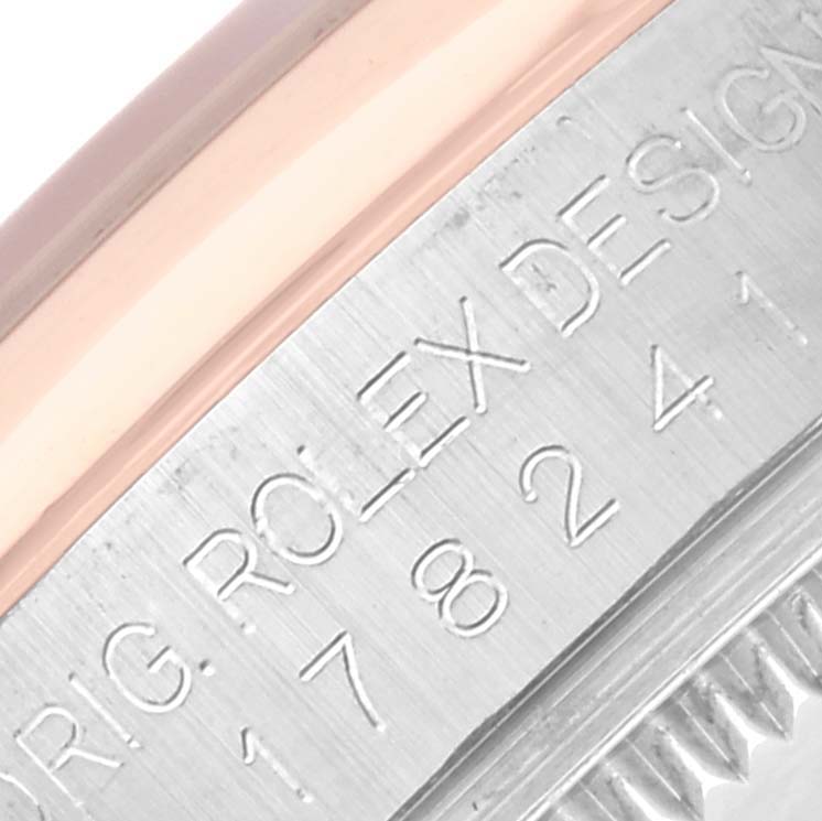 The image shows an angled close-up of a Rolex Mid-Size 178241 Women's Steel and Gold (two tone) White Dial 178241 Women's Steel and Gold (two tone) White Dial watch's bezel and engraved markings.