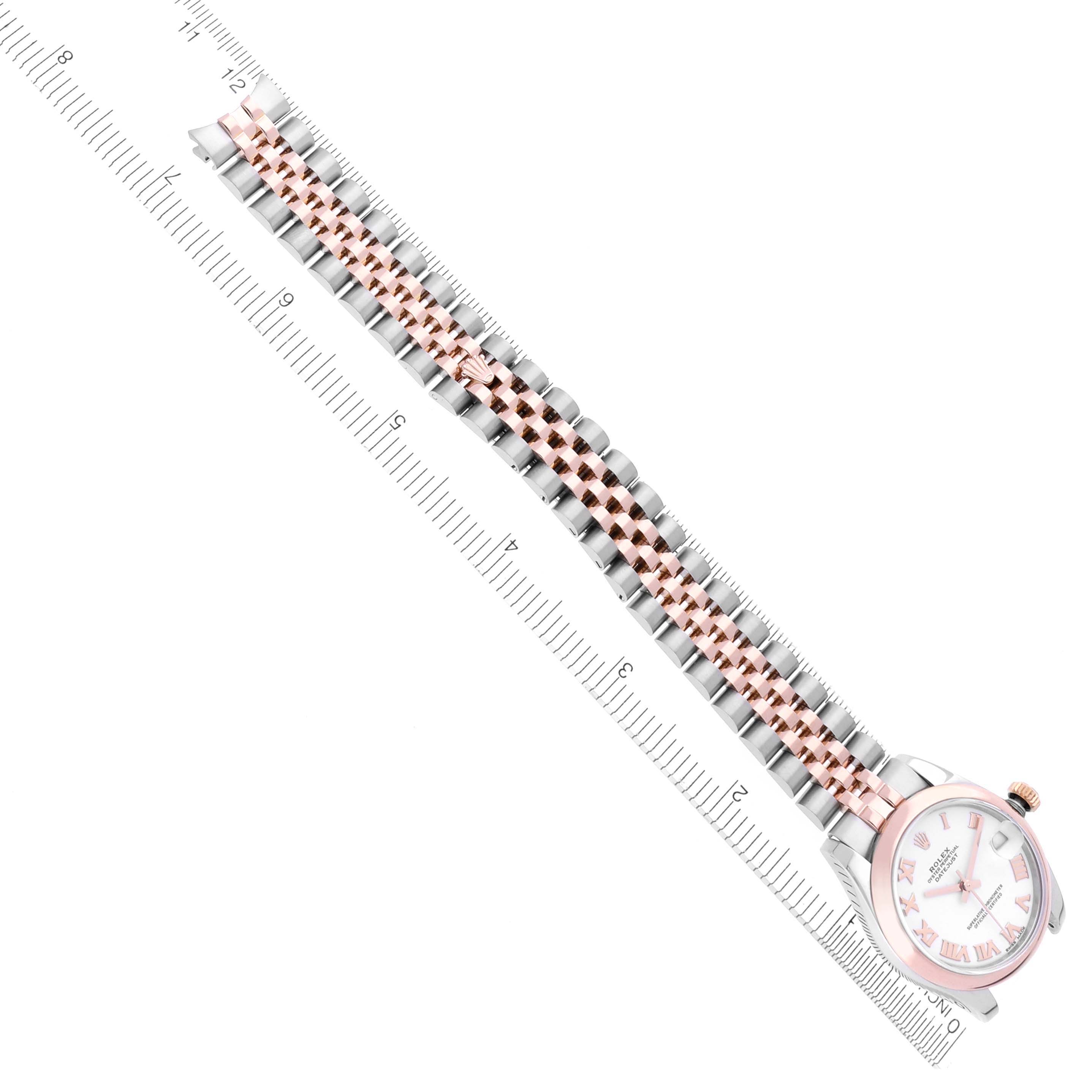 The Rolex Mid-Size 178241 Women's Steel and Gold (two tone) White Dial 178241 Women's Steel and Gold (two tone) White Dial model is shown from a top-down angle, featuring its dial, bezel, and two-tone bracelet alongside a ruler.