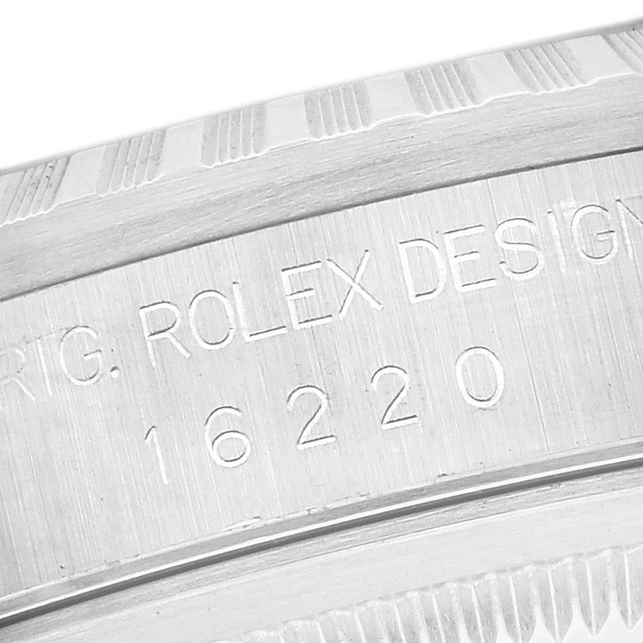 The image shows a close-up of the Rolex Datejust 16220 Men's Stainless Steel Blue Dial 16220 Men's Stainless Steel Blue Dial's engraved case side, highlighting the model number.