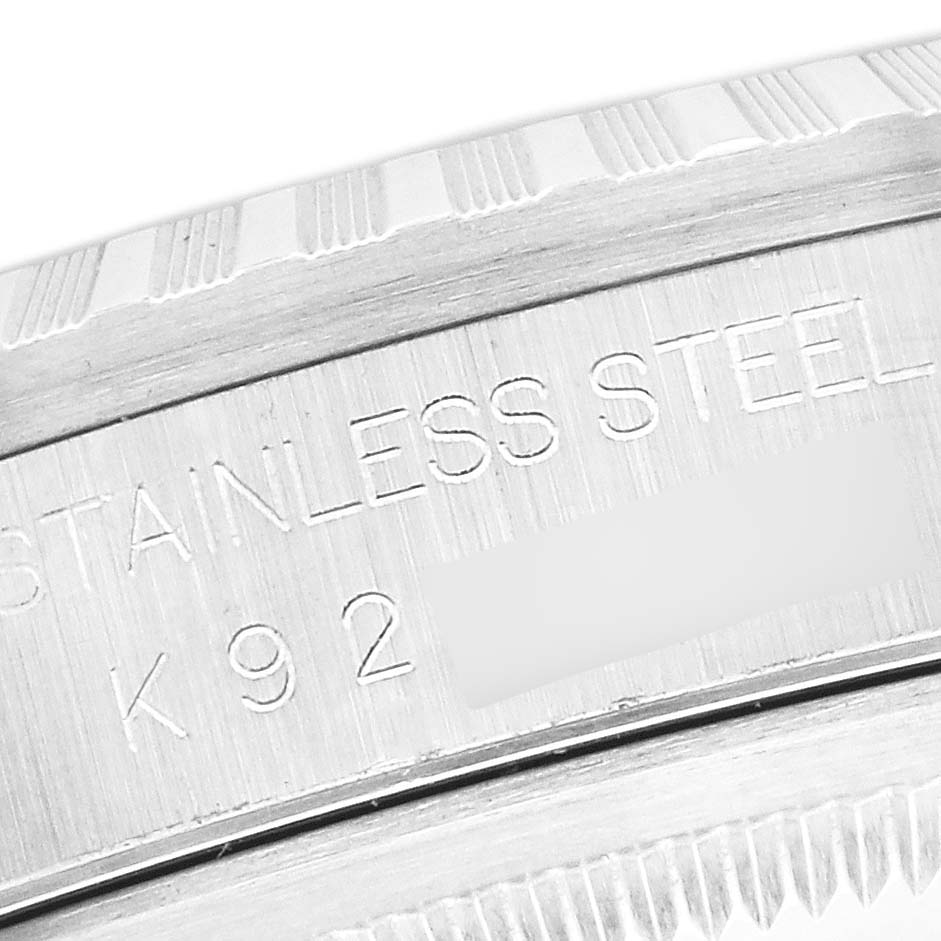 The image shows a close-up of the engraved stainless steel Rolex Datejust 16220 Men's Stainless Steel Blue Dial 16220 Men's Stainless Steel Blue Dial watch case.