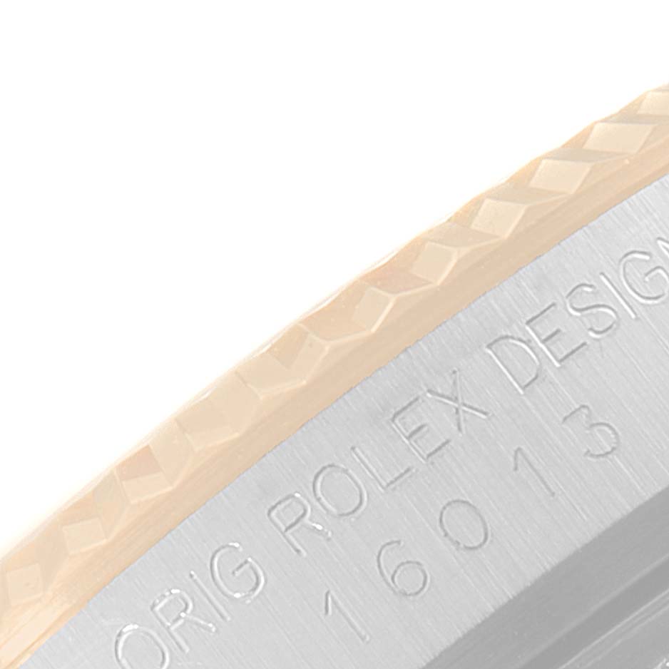 This image shows a close-up of the outer edge and casing of a Rolex Vintage Collection 16013 Men's Steel and Gold (two tone) Champagne Dial 16013 Men's Steel and Gold (two tone) Champagne Dial model watch, featuring engraved text.