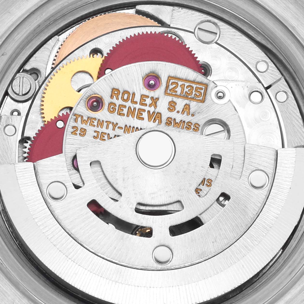 The image shows a close-up of the Rolex Datejust 69173 Women's Steel and Gold (two tone) Red Dial 69173 Women's Steel and Gold (two tone) Red Dial movement mechanics, displaying gears and inscriptions.