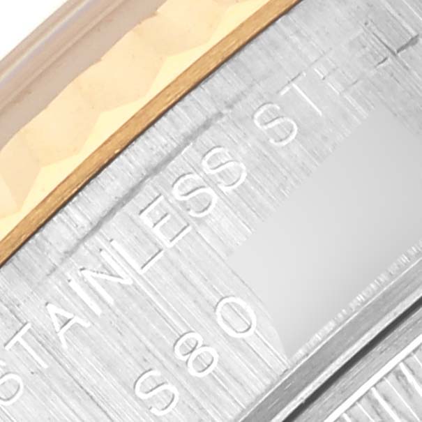 The image shows a close-up of the bezel and edge of the case for a Rolex Datejust 69173 Women's Steel and Gold (two tone) Red Dial 69173 Women's Steel and Gold (two tone) Red Dial watch, highlighting the "Stainless Steel" engraving.