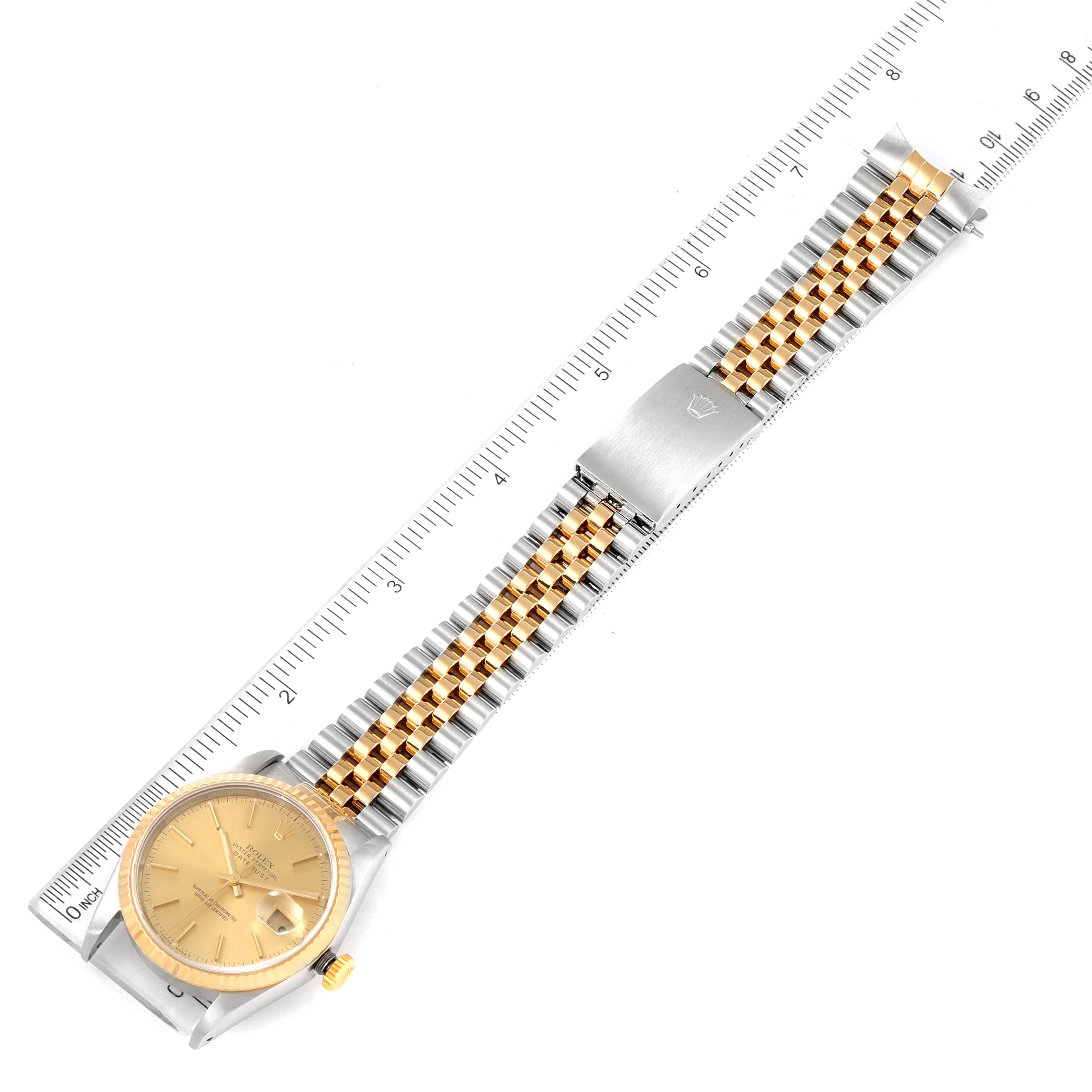 The image shows a Rolex Datejust 16233 Men's Steel and Gold (two tone) Champagne Dial 16233 Men's Steel and Gold (two tone) Champagne Dial watch at a top-down angle, displaying the face, band, and clasp with a ruler for scale.