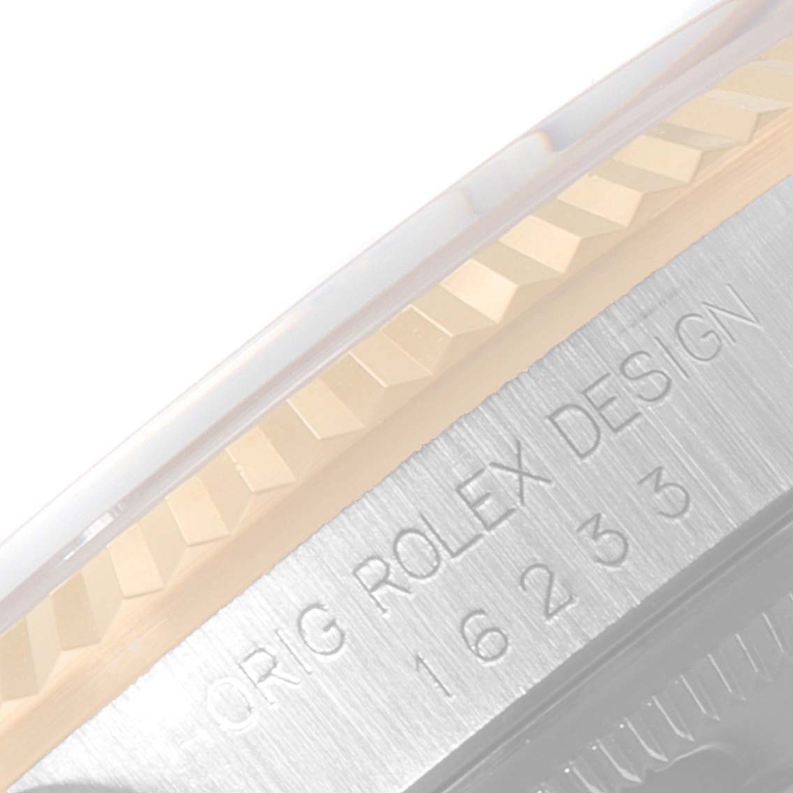 The image shows a close-up of the side of a Rolex Datejust 16233 Men
s Steel and Gold (two tone) Champagne Dial 16233 Men
s Steel and Gold (two tone) Champagne Dial, highlighting the fluted bezel and model number engraving.