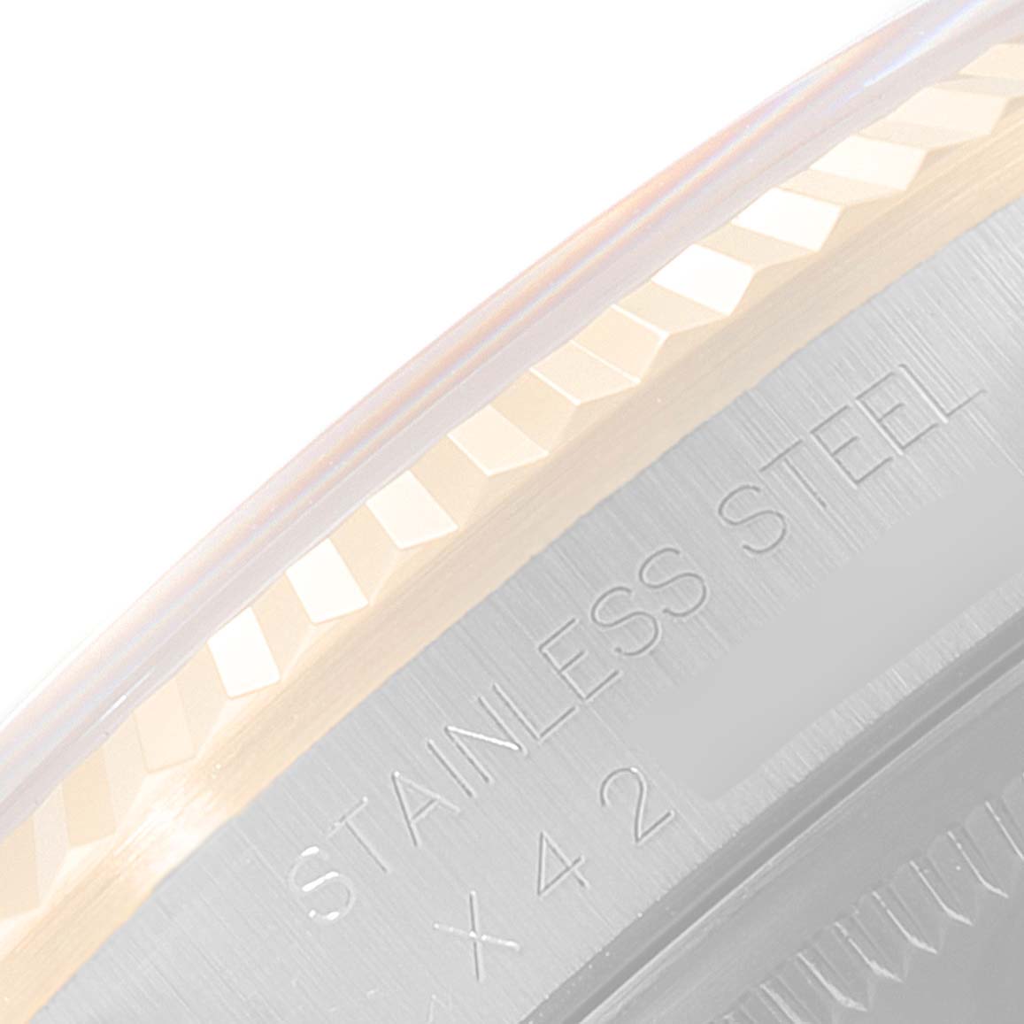 The image shows a close-up of the stainless steel bezel and part of the flange on a Rolex Datejust 16233 Men
s Steel and Gold (two tone) Champagne Dial 16233 Men
s Steel and Gold (two tone) Champagne Dial watch.