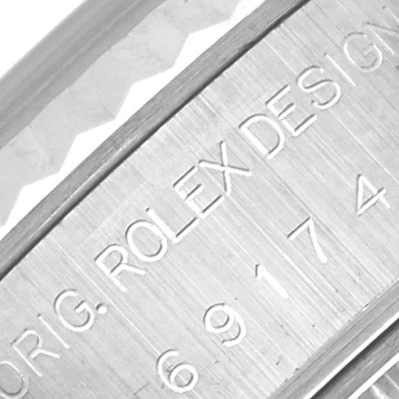 The image shows an engraved side of the case of a Rolex Datejust 69174 Women's Stainless Steel Blue Dial 69174 Women's Stainless Steel Blue Dial watch, highlighting the model and design information.