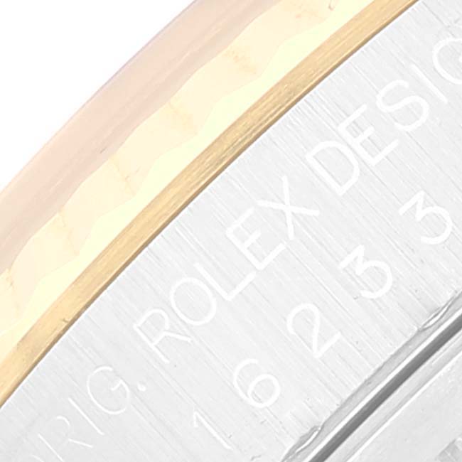 This is a close-up image of the engraved bezel or rehaut of a Rolex Datejust 16233 Men's Steel and Gold (two tone) Black Dial 16233 Men's Steel and Gold (two tone) Black Dial watch.