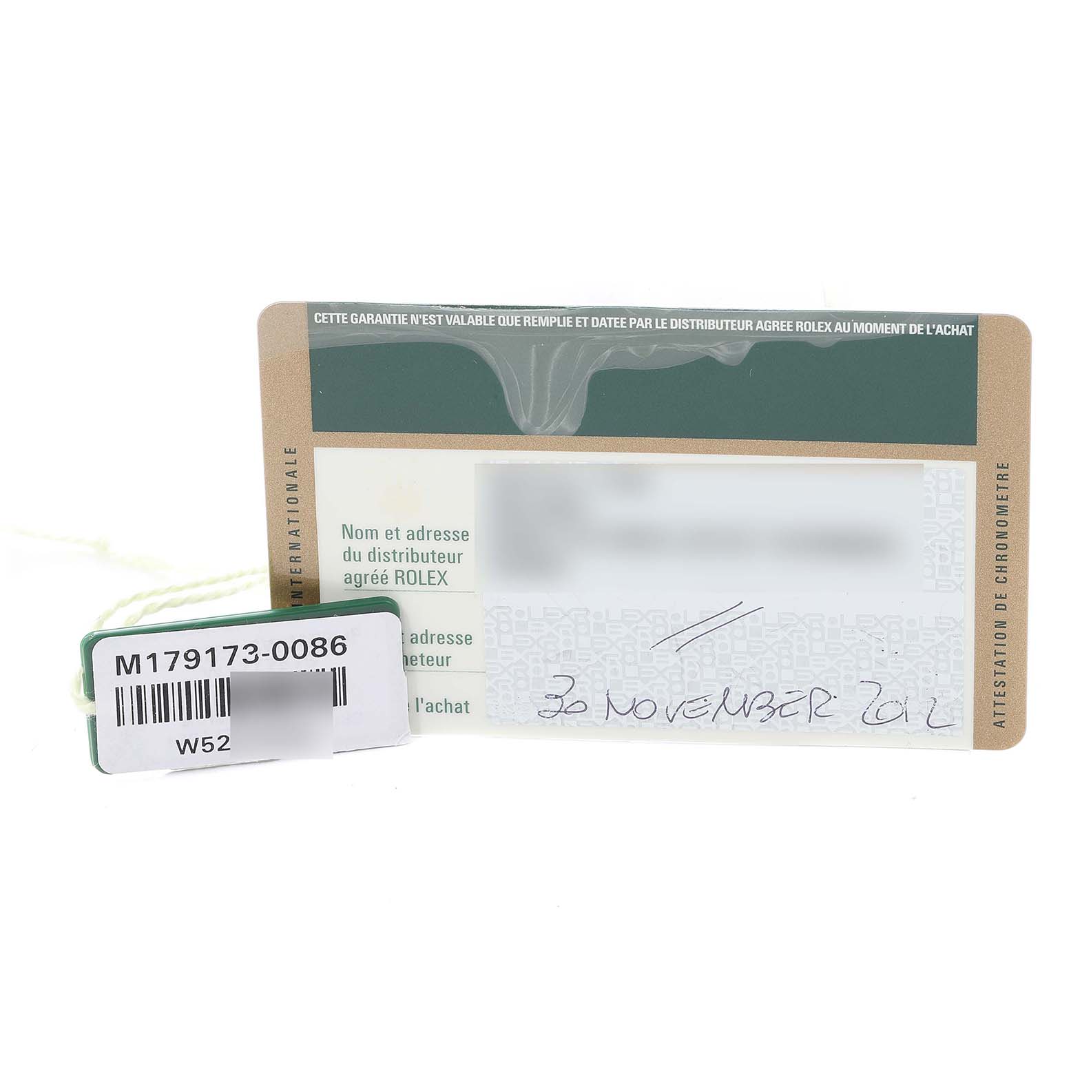The image shows a warranty card and a tag with a serial number for the Rolex Datejust 179173 Women's Steel and Gold (two tone) Silver Dial 179173 Women's Steel and Gold (two tone) Silver Dial model.