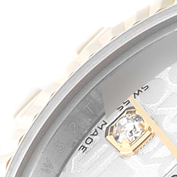 This close-up image of the Rolex Datejust 179173 Women's Steel and Gold (two tone) Silver Dial 179173 Women's Steel and Gold (two tone) Silver Dial watch shows the edge of the bezel and part of the dial with a diamond marker.