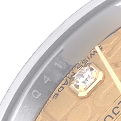This image shows a close-up angle of a Rolex Datejust 179173 Women's Steel and Gold (two tone) Champagne Dial 179173 Women's Steel and Gold (two tone) Champagne Dial watch, highlighting the bezel and part of the dial with a diamond marker.