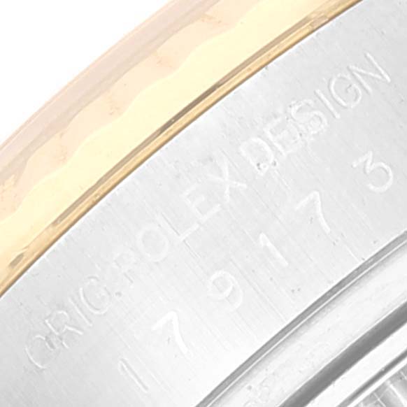 This image shows a close-up of the engraved text and metal detailing on the side of the Rolex Datejust 179173 Women's Steel and Gold (two tone) Champagne Dial 179173 Women's Steel and Gold (two tone) Champagne Dial watch.