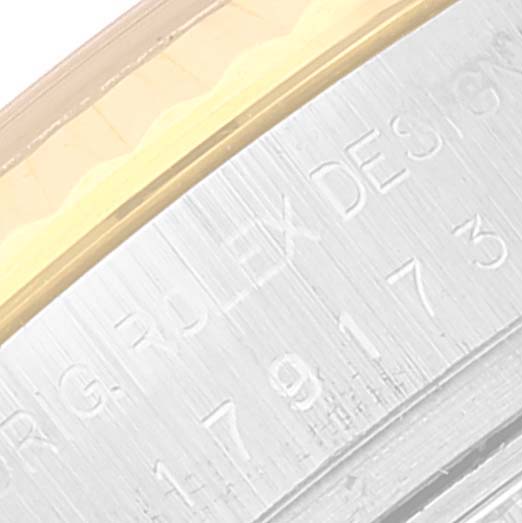 This close-up image shows the edge of the bezel and case with the model number inscription on the Rolex Datejust 179173 Women's Steel and Gold (two tone) Blue Dial 179173 Women's Steel and Gold (two tone) Blue Dial watch.