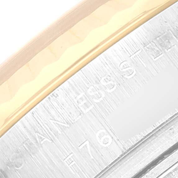 This close-up image shows part of the case and engraving of a Rolex Datejust 179173 Women's Steel and Gold (two tone) Blue Dial 179173 Women's Steel and Gold (two tone) Blue Dial watch.