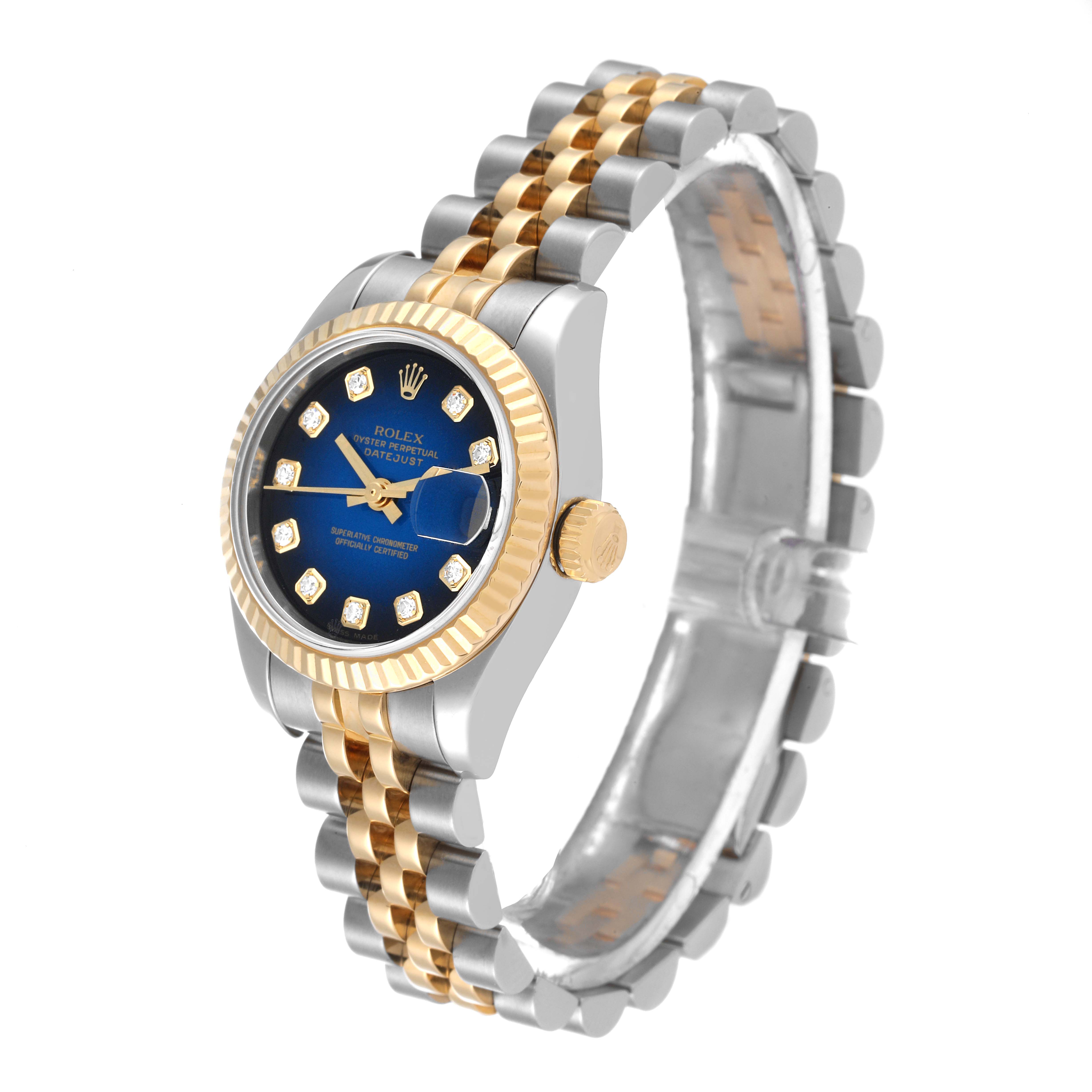 The Rolex Datejust 179173 Women's Steel and Gold (two tone) Blue Dial 179173 Women's Steel and Gold (two tone) Blue Dial watch is shown at an angled side view, highlighting its gold and silver bracelet, blue dial, and fluted bezel.
