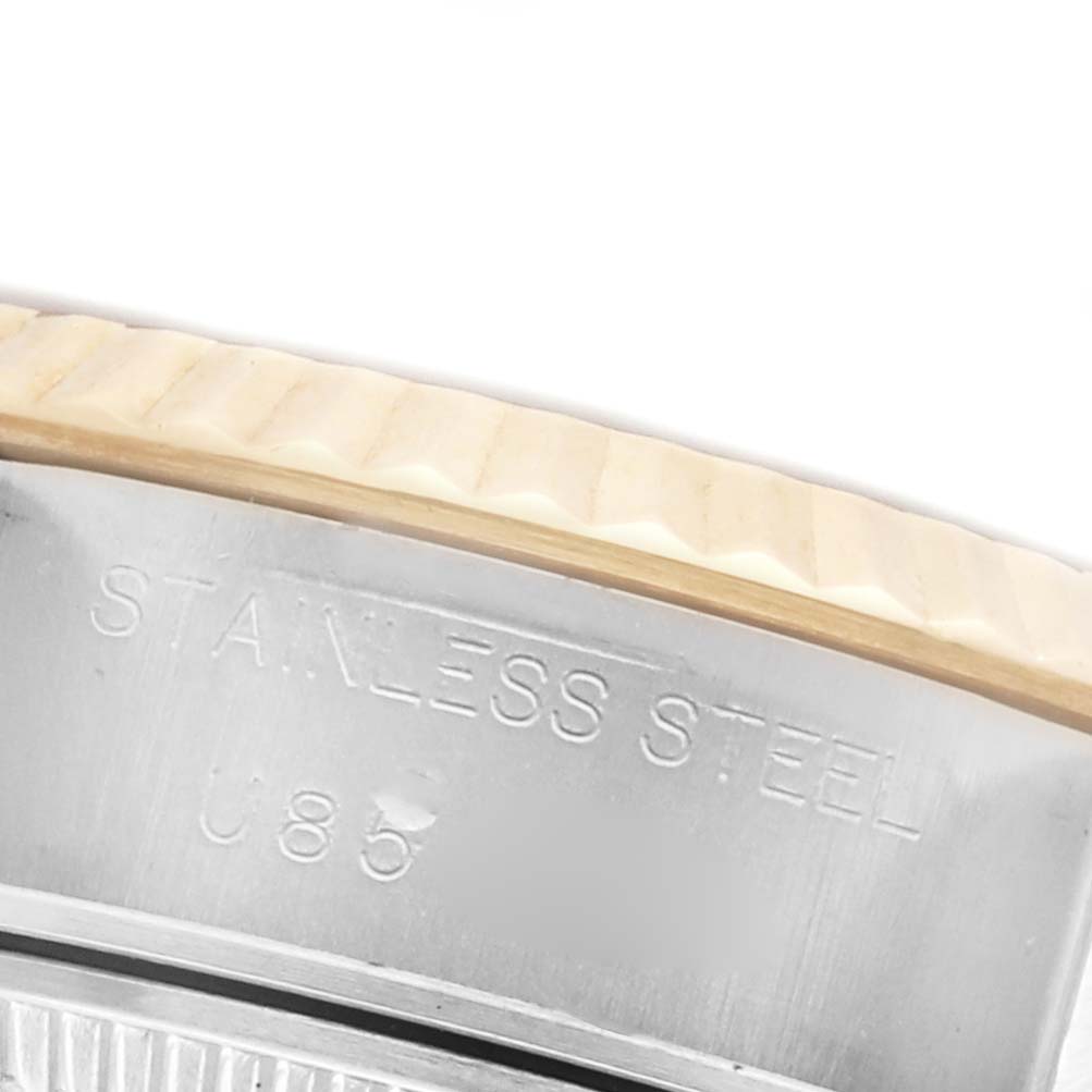 The image shows a close-up of the Rolex Datejust 69173 Women's Steel and Gold (two tone) Champagne Dial 69173 Women's Steel and Gold (two tone) Champagne Dial watch's fluted bezel and stainless steel marking.