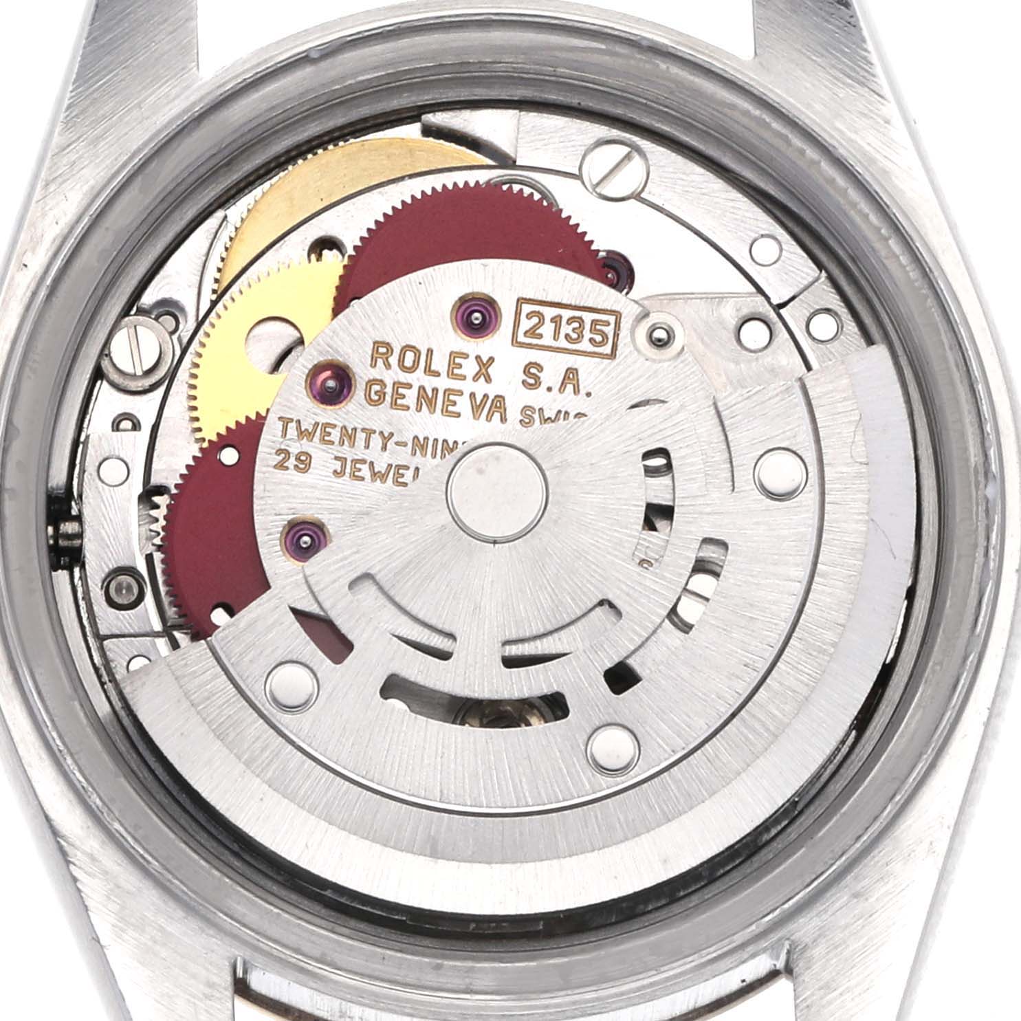 The image shows the movement of a Rolex Datejust 69173 Women's Steel and Gold (two tone) Champagne Dial 69173 Women's Steel and Gold (two tone) Champagne Dial, highlighting gears, jewels, and engravings from the back angle.