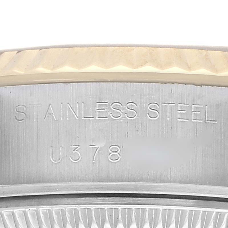 The image shows a close-up of the side of a Rolex Datejust 69173 Women's Steel and Gold (two tone) Champagne Dial 69173 Women's Steel and Gold (two tone) Champagne Dial watch, highlighting the stainless steel case and engraved text.