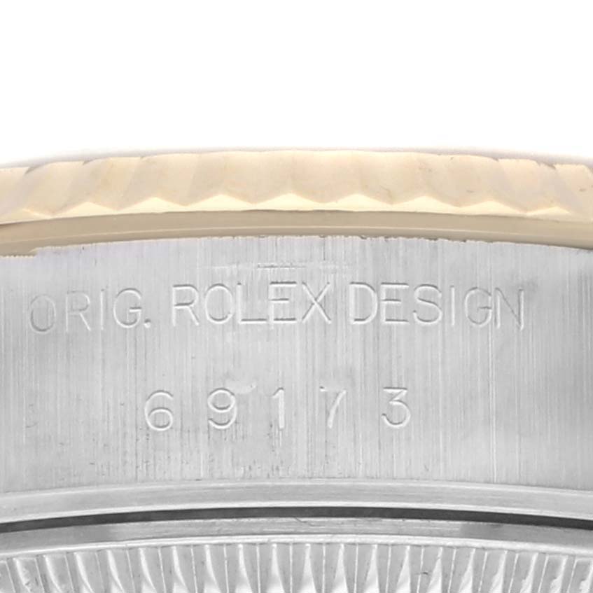 The image shows an angled close-up of the side of a Rolex Datejust 69173 Women's Steel and Gold (two tone) Champagne Dial 69173 Women's Steel and Gold (two tone) Champagne Dial watch, highlighting the engraved model number on the case.