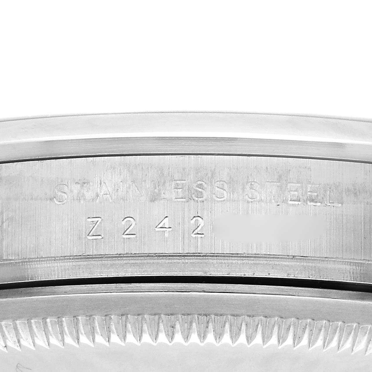 The image shows a close-up of the side of the case and bezel of a Rolex Explorer 114270 Men's Stainless Steel Black Dial 114270 Men's Stainless Steel Black Dial watch, displaying the "STAINLESS STEEL" engraving.