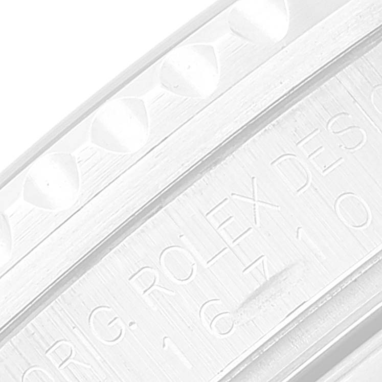 The image shows a close-up of the engraved side of the bezel and inner case of a Rolex GMT-Master 16710 Men
s Stainless Steel Black Dial 16710 Men
s Stainless Steel Black Dial watch.
