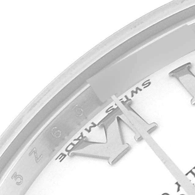 The image shows a close-up angle of a Roman numeral and the "Swiss Made" text on the dial of a Mid-Size Rolex watch.