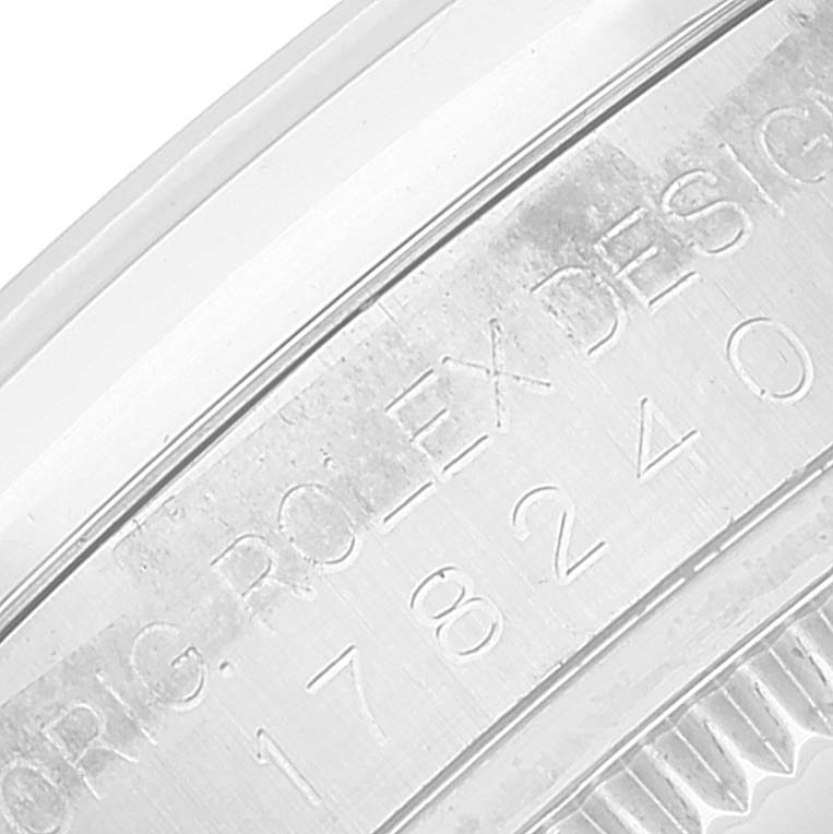 The image shows an up-close view of the casing with engraved text on a Mid-Size Rolex watch.
