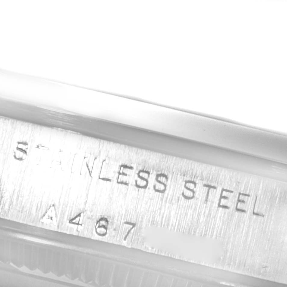 This image shows a close-up of the engravings on the stainless steel case of a Mid-Size Rolex watch.