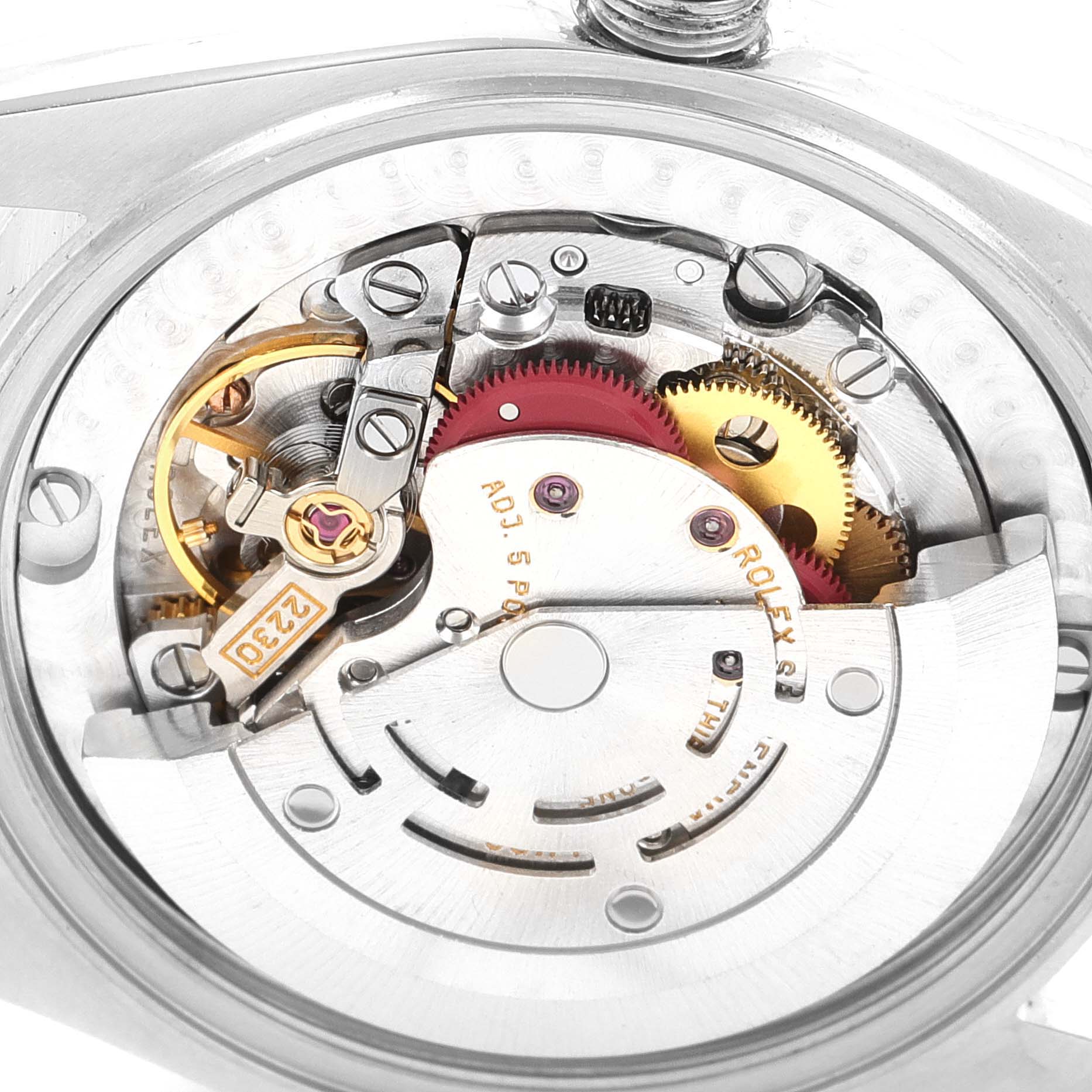The image shows the internal mechanical components of a Mid-Size Rolex watch from a close-up angle.