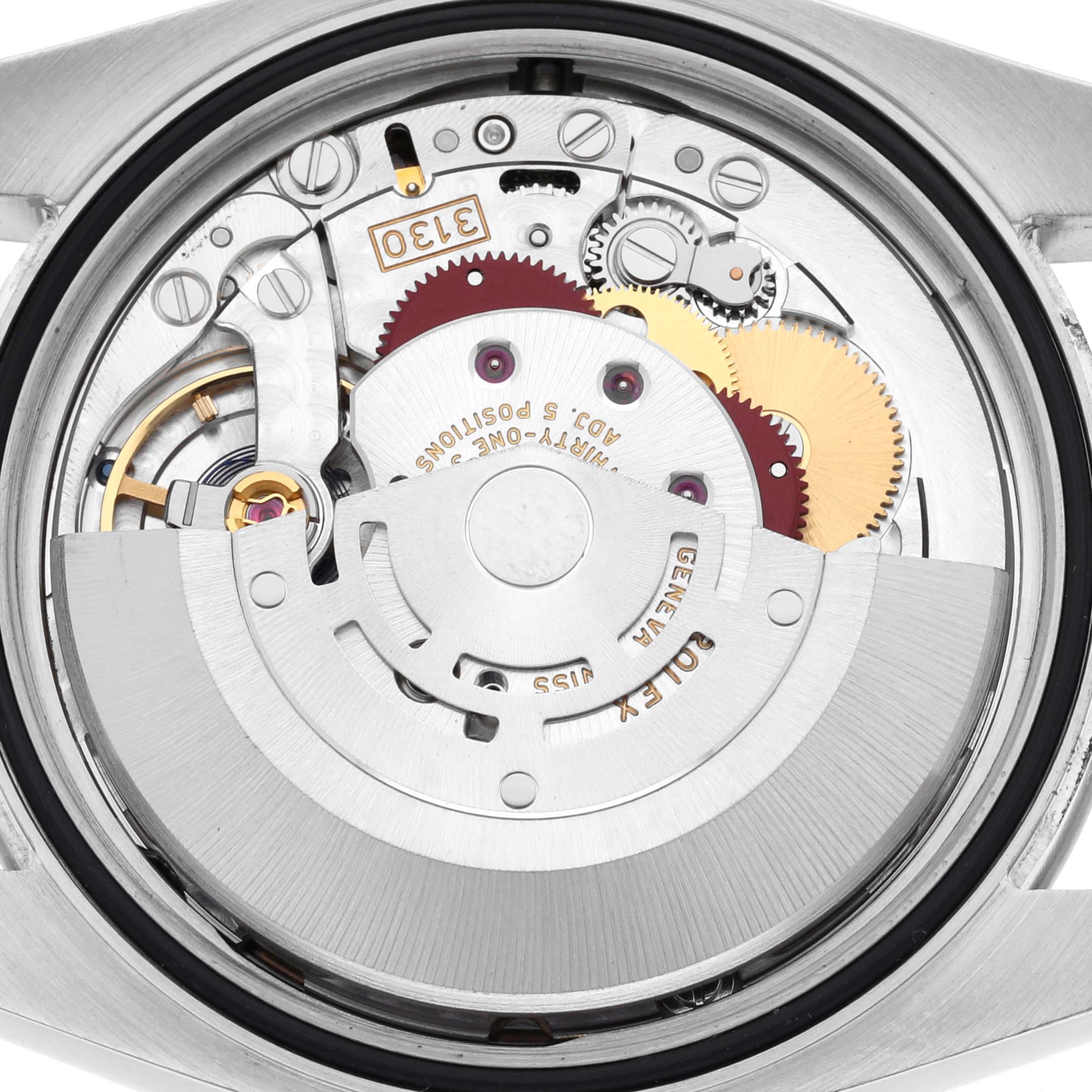 The image shows a close-up of the movement inside a Rolex Oyster Perpetual 116000 Men's Stainless Steel Champagne Dial 116000 Men's Stainless Steel Champagne Dial watch, highlighting gears and components.